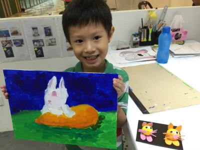 Fine momentum art class student showcasing his artwork