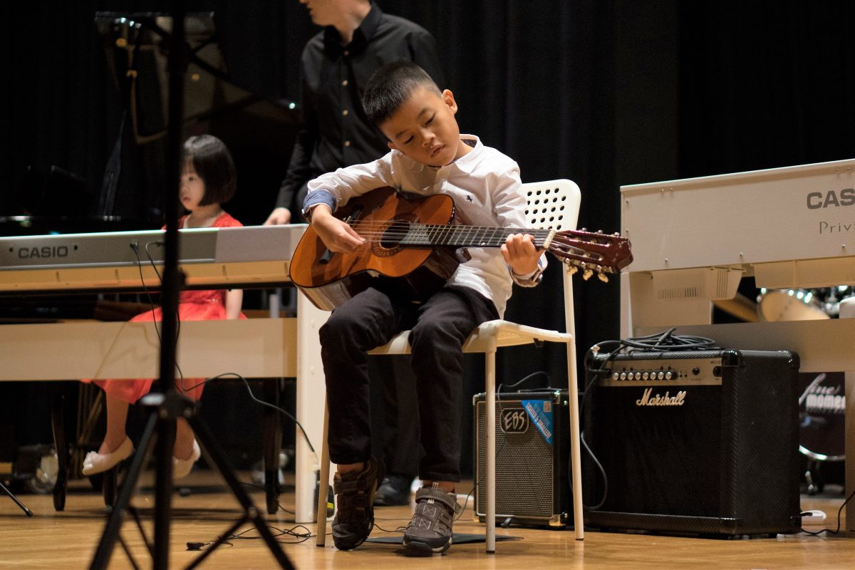 Fine Momentum music class student performing on stage