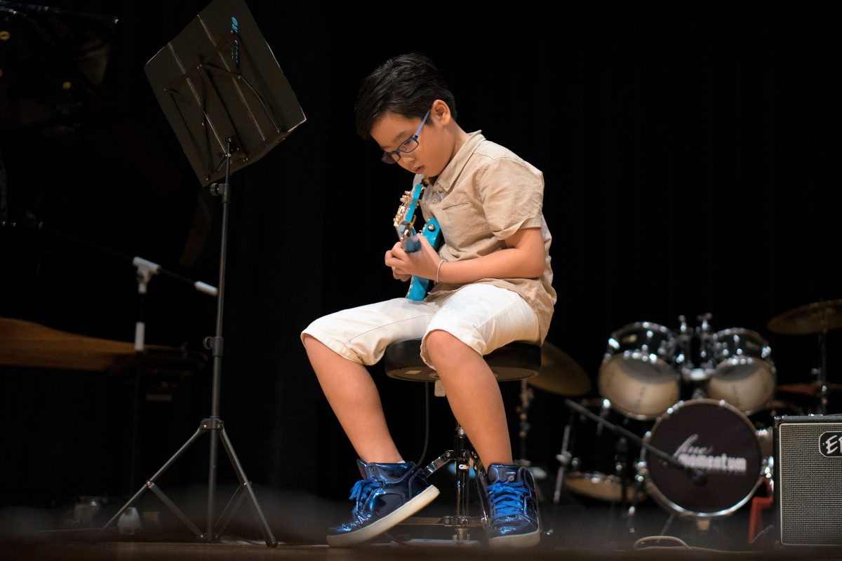Fine Momentum music class student performing on stage