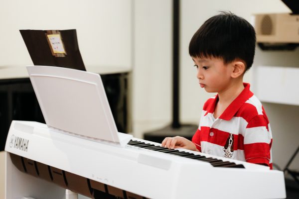 Fine momentum piano music lesson student performing the piano