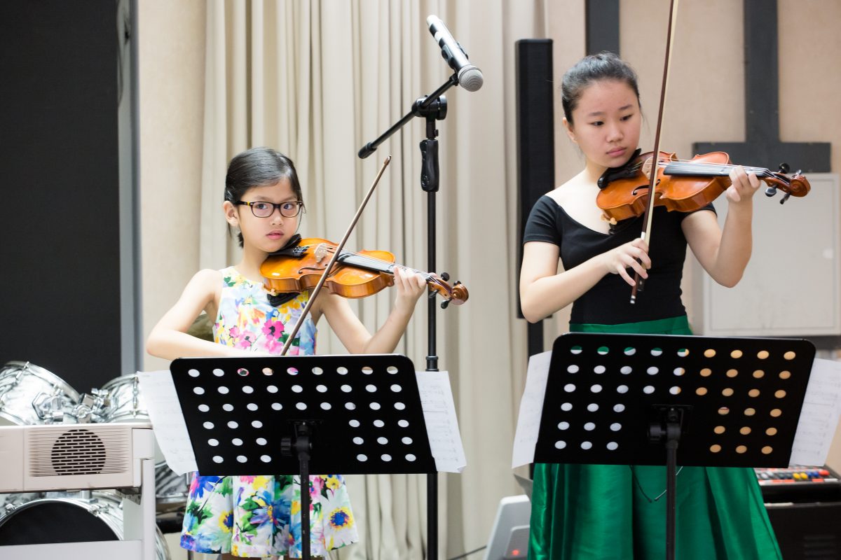 Fine momentum music lesson student performing the violin