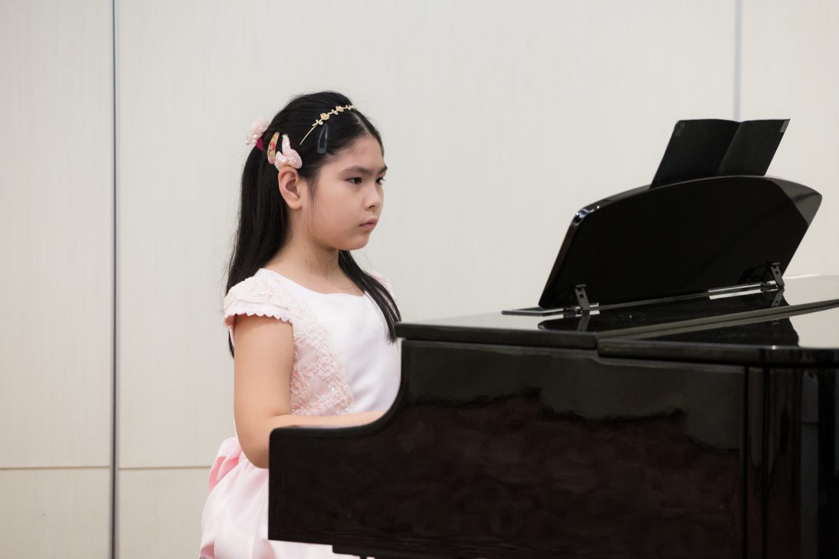 Fine momentum piano music lesson student performing the piano
