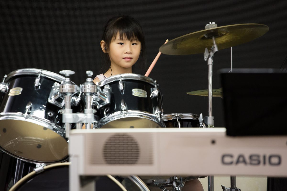 Fine momentum music lesson student performing the drums