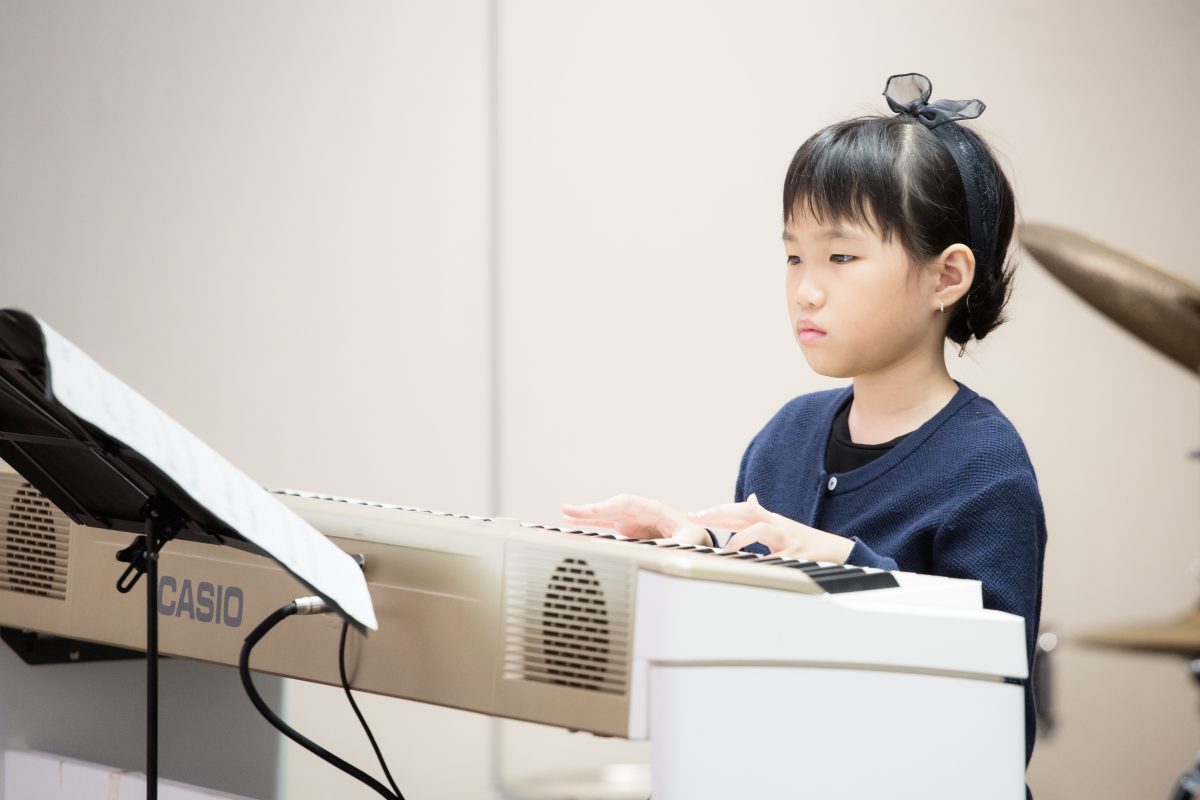 Fine momentum music lesson student performing the piano