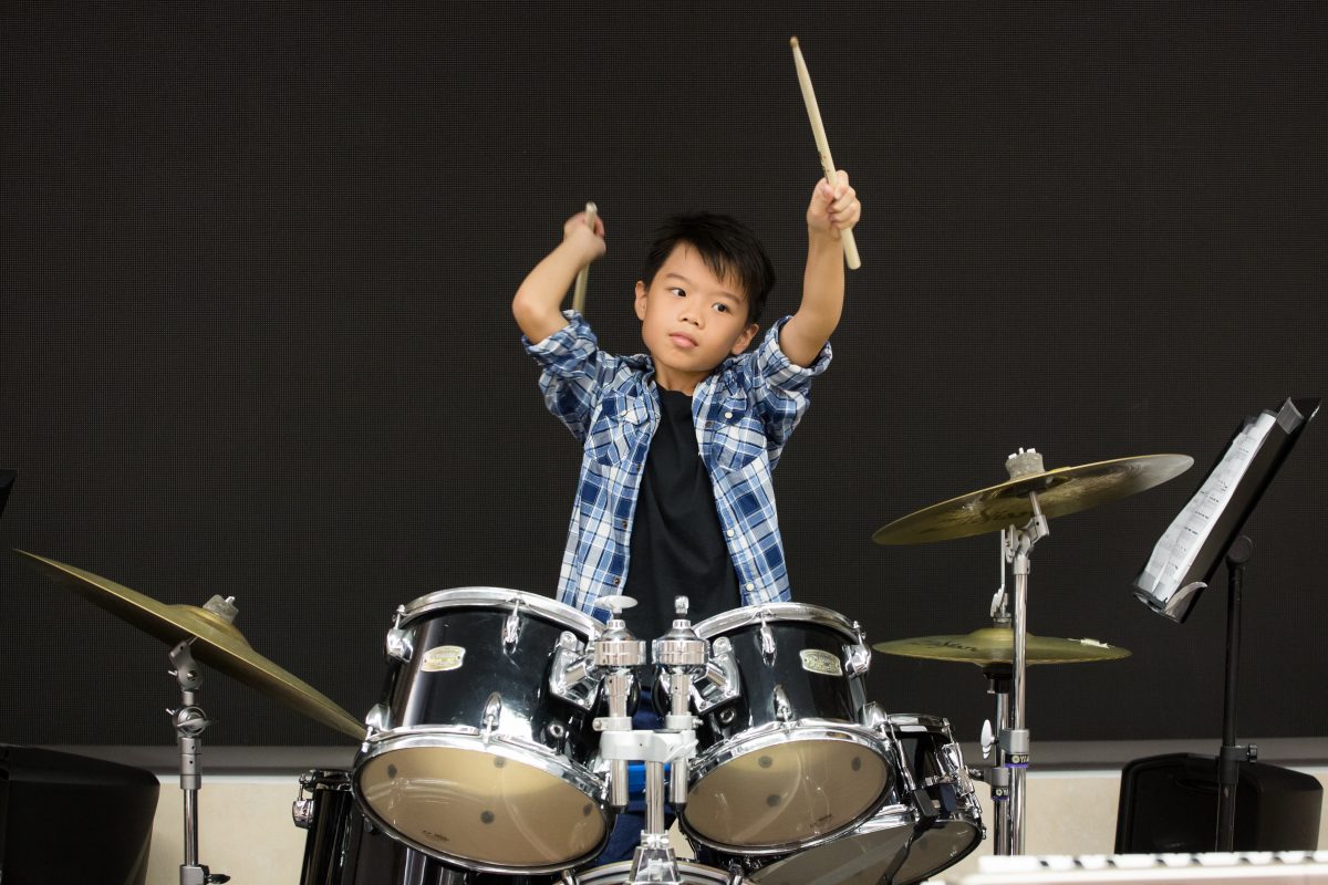 Fine momentum music lesson student performing the drums
