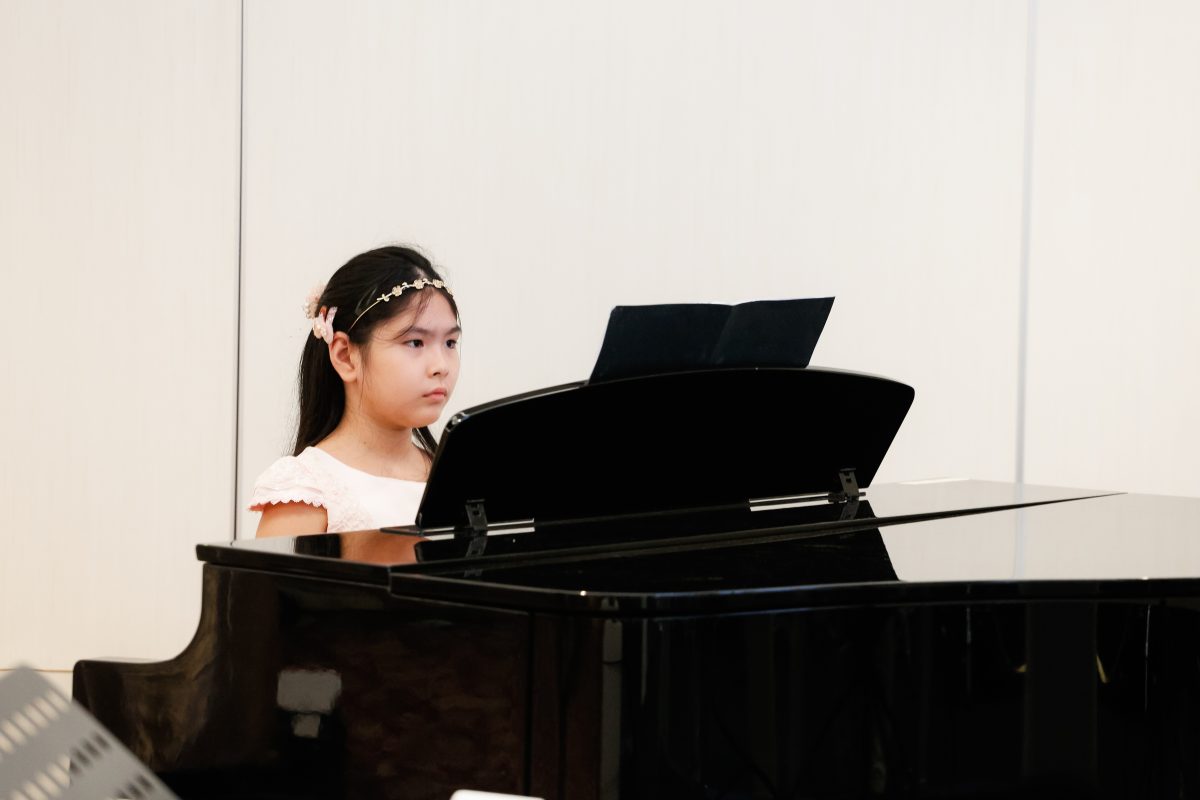 Fine momentum music lesson student performing the piano