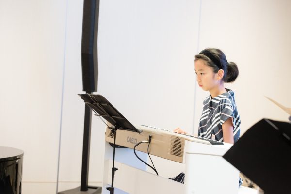 Fine momentum music lesson student performing the piano