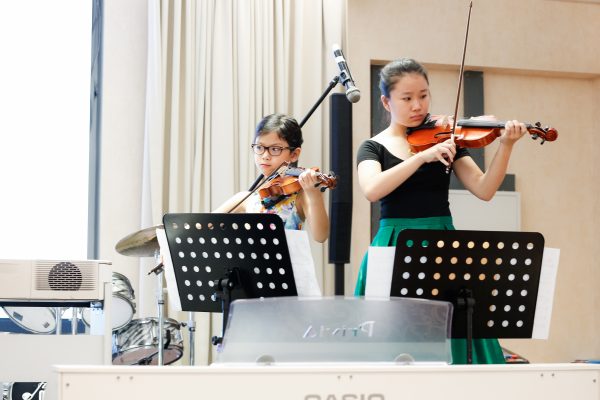 Fine momentum music lesson student performing the violin