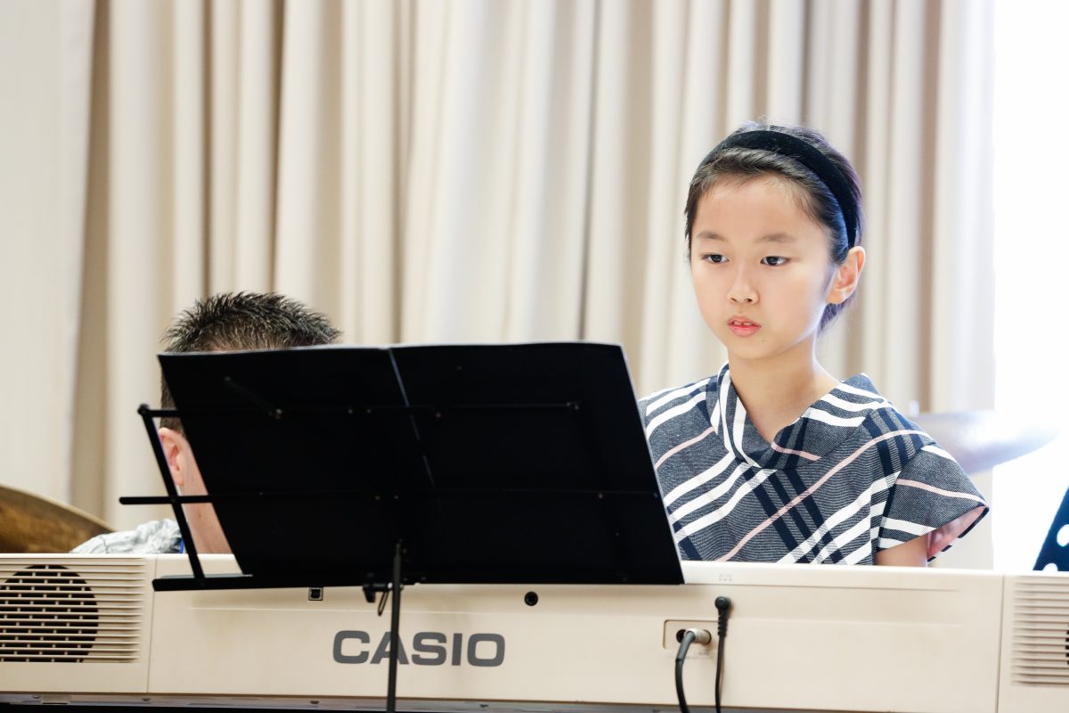 Fine momentum music lesson student performing the piano