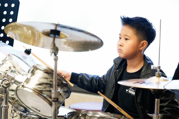 Fine momentum music lesson student performing the drums
