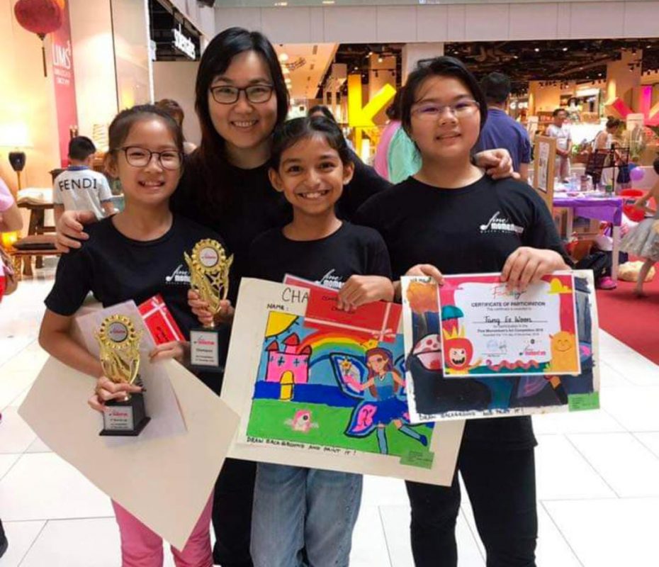 Our art students at Fine momentum showcasing their artwork with instructor at art competition