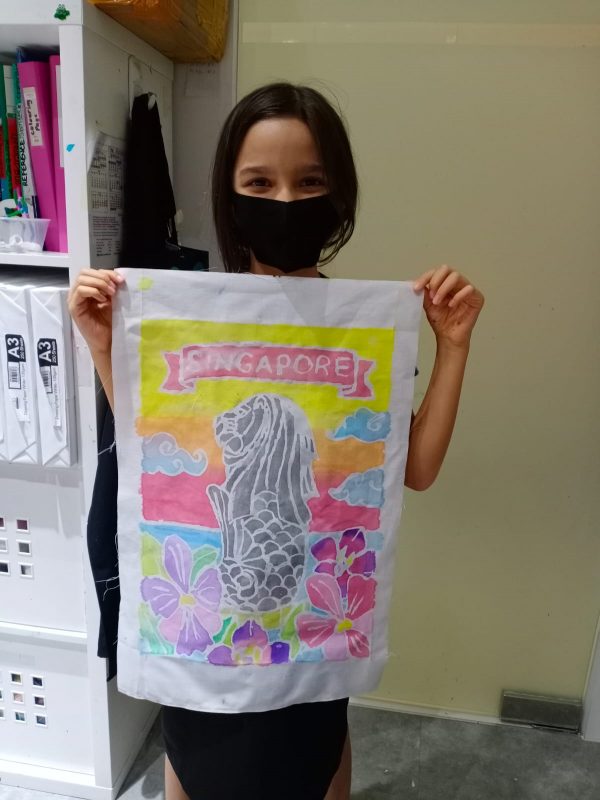 Fine momentum art class student showcasing her artwork