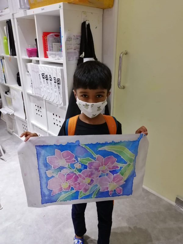 Fine momentum art class student showcasing his artwork