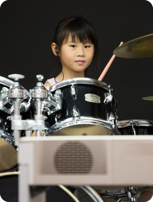 Fine momentum music class drum set student performing