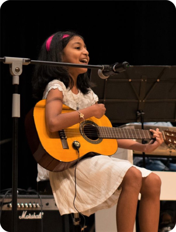 Fine momentum music class student singing and performing on stage