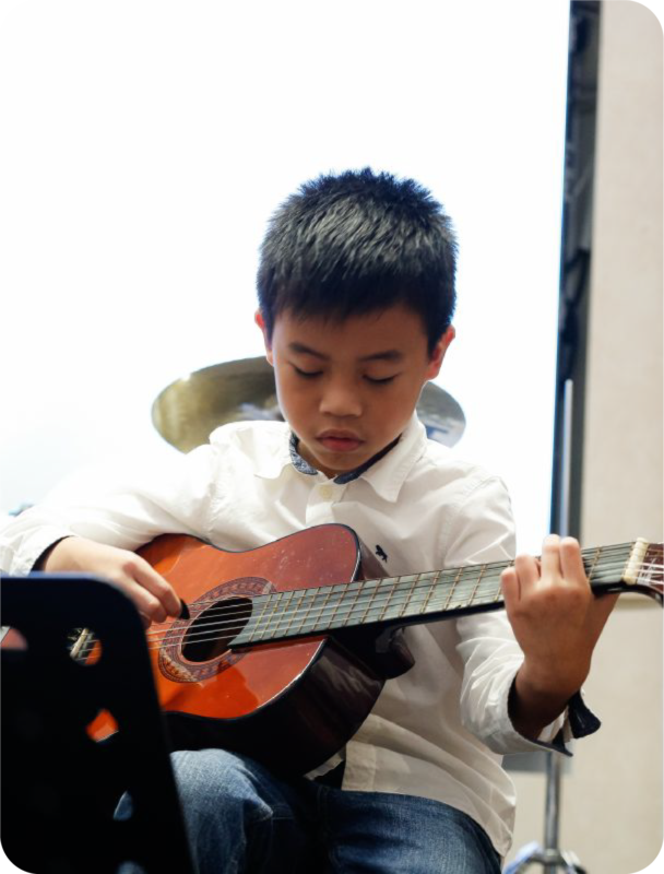 Fine momentum music class student performing the guitar