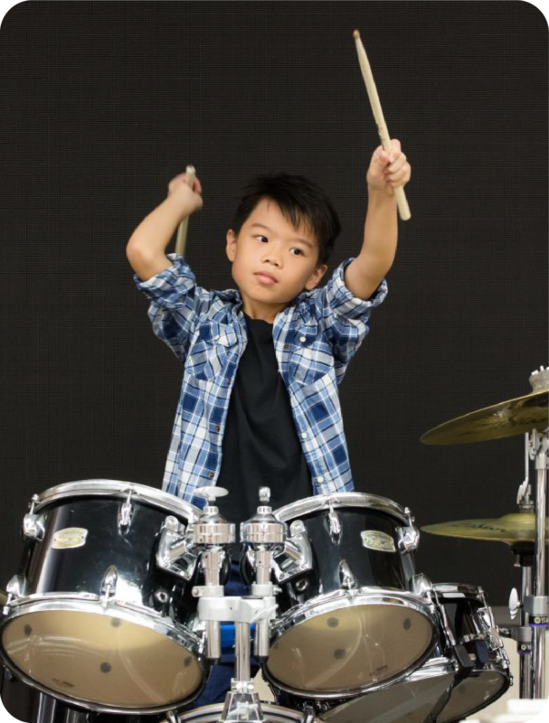 Fine momentum music class student performing the drums