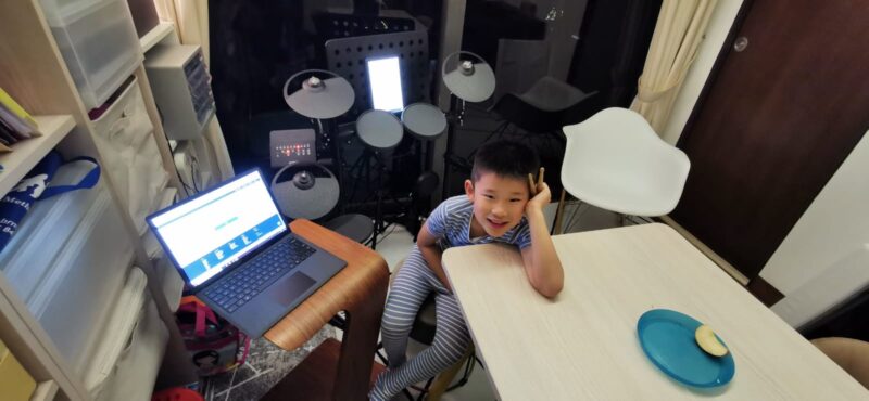 Fine momentum online music drum lesson student enjoying