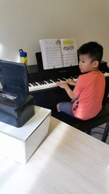 Fine momentum online music piano lesson student enjoying