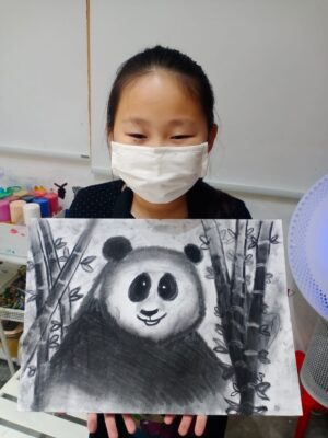 Fine momentum art class student showcasing her artwork