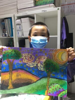 Fine momentum art class student showcasing his artwork