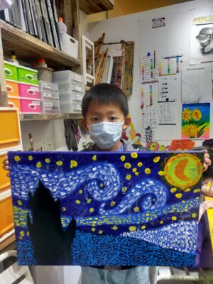Fine momentum art class student showcasing his artwork