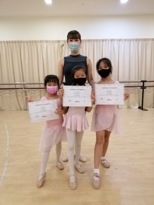 Fine momentum ballet lesson students posing with dance certificate