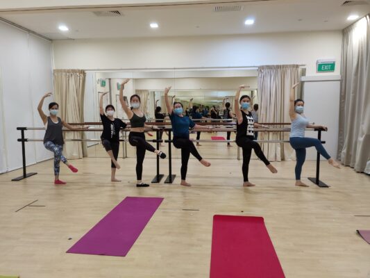 Fine momentum adult ballet students showcasing ballet poses