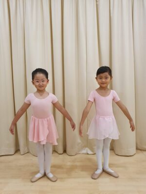 Fine momentum ballet classes for kids student doing ballet poses