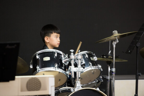 Fine momentum drum classes for kids student playing the drums