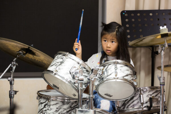 Fine momentum drum classes student playing the drums