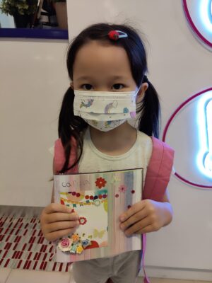 Fine Momentum student showcasing her art after art lessons