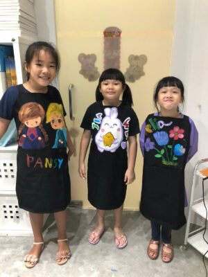 Our art students in their painted aprons after art lessons at Fine Momentum